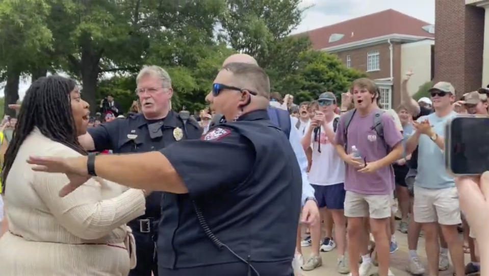 In this photo taken from video provided by Stacey J. Spiehler, a pro-Palestinian protester is confronted by hecklers at the University of Mississippi, Thursday, May 2, 2024, in Oxford, Miss. The hecklers vastly outnumbered pro-Palestine demonstrators and video shot by a student journalist showed one white heckler making monkey gestures and noises at a Black woman who was supporting pro-Palestine protesters. (Stacey J. Spiehler via AP)