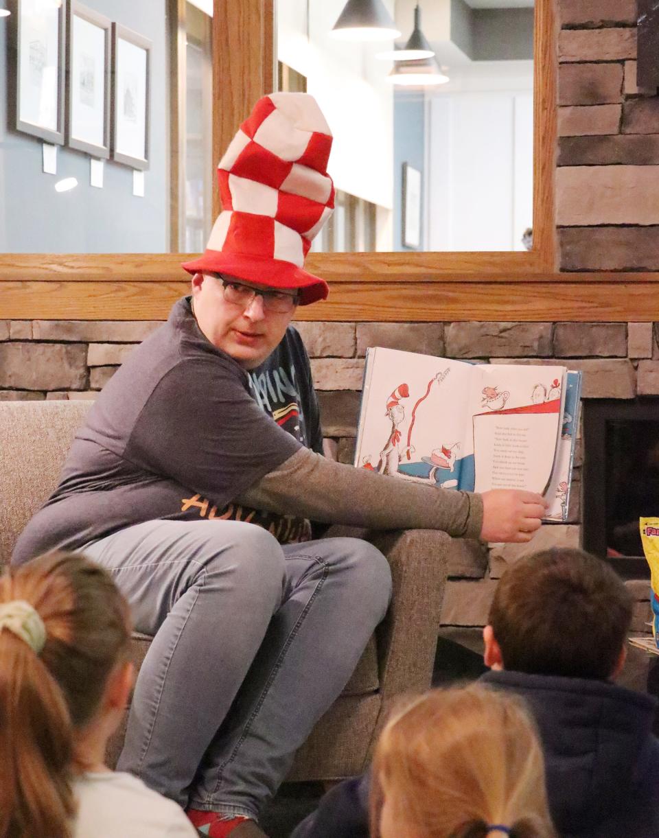 Sturgis Wenzel Elementary School first grade teacher Tyson Dilts reads a book to children March 1 at Sturgis District Library.