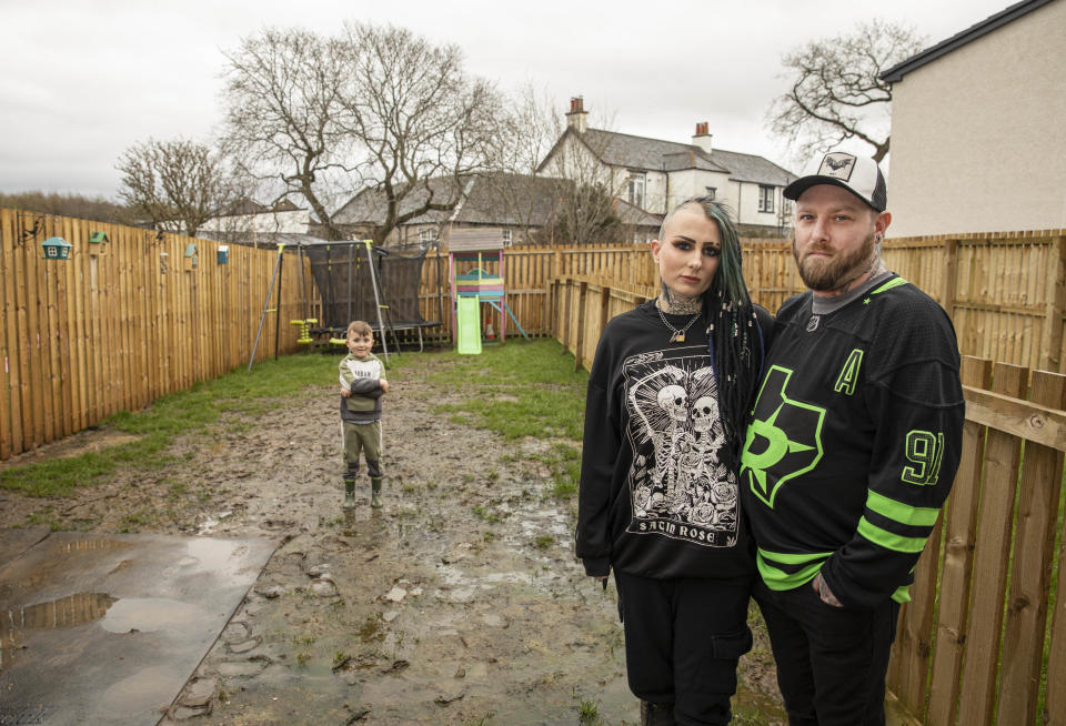 Ellis Reid and her partner Douglas Horn. 
Ellis is living with her partner and her four-year-old son Landon, at a new social housing complex in the village of Dundonald owned by Riverside Housing. 
Since moving in August their garden has become a complete swamp, with algae now growing and the grass flooded. 
When Ellis complained about this she was told by a sub contractor to use a pitch fork and claims they blamed the mess on her four-year-old son and her two dogs.