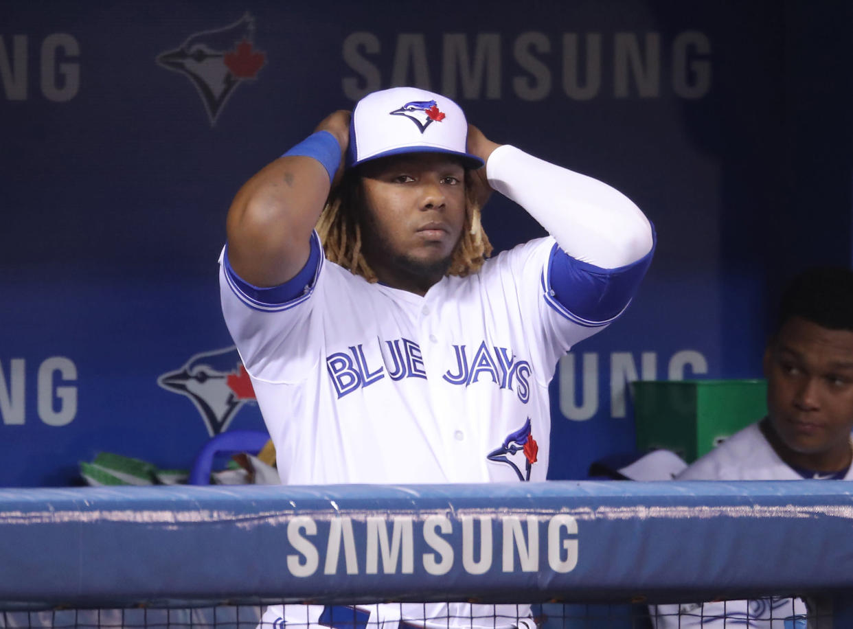 TORONTO, ON - MAY 20: Vladimir Guerrero Jr. #27 of the Toronto Blue Jays looks on from the dugout during MLB game action against the Boston Red Sox at Rogers Centre on May 20, 2019 in Toronto, Canada. (Photo by Tom Szczerbowski/Getty Images)