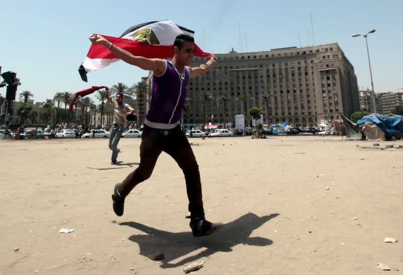 FILE PHOTO: An Egyptian man celebrates after a court sentenced deposed Egyptian president Hosni Mubarak to life in prison at Tahrir Square in Cairo