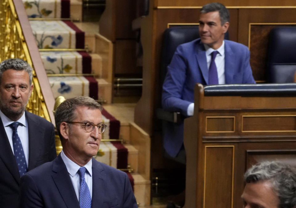 FILE - Conservative Popular Party leader Alberto Núñez Feijoo walks past acting Prime Minister Pedro Sánchez, right, before the start of a voting session at the Spanish parliament in Madrid, Spain, on Aug. 17, 2023. The leader of Spain’s conservatives will have his opportunity to form a new government this week in what has been preordained as a lost cause given his lack of support in the Parliament. Alberto Núñez Feijóo's Popular Party won the most seats from inconclusive elections in July but fell well short of a majority. (AP Photo/Paul White, File)