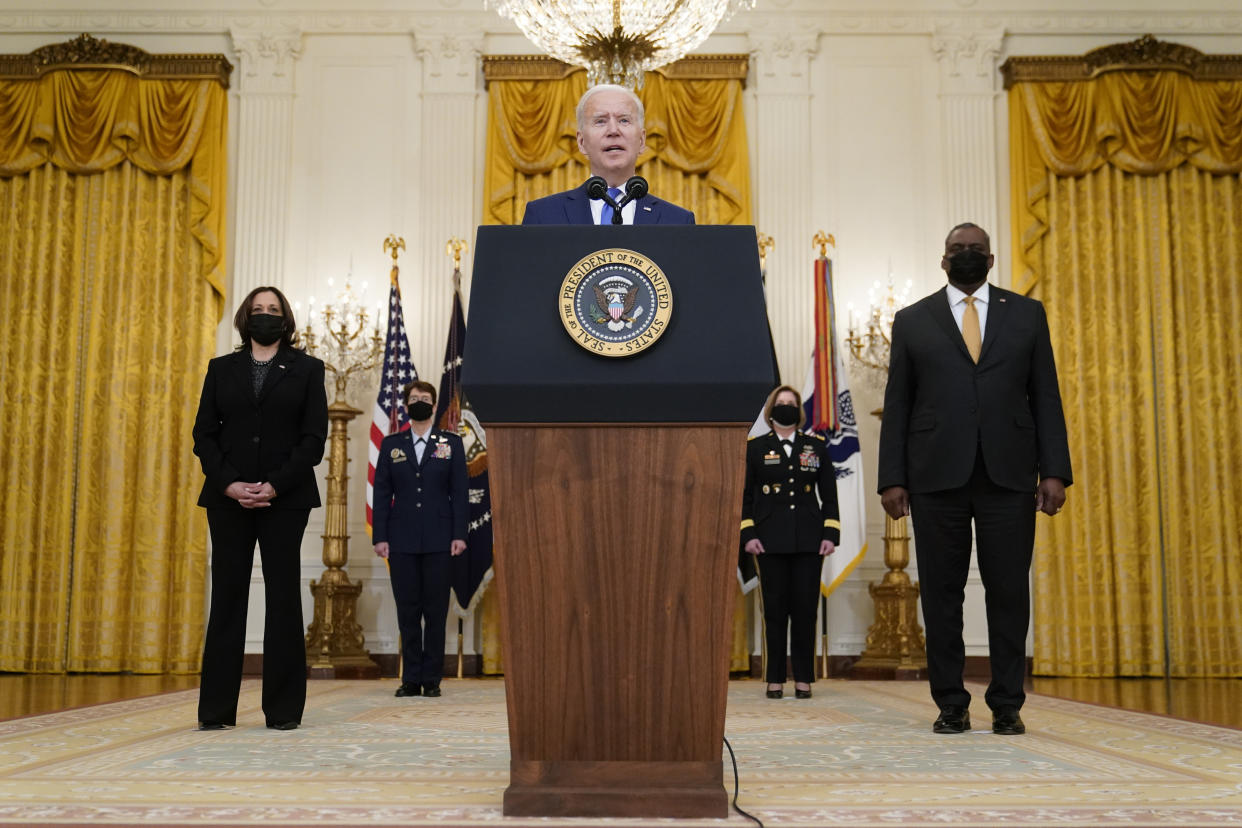 President Joe Biden speaks during an event to mark International Women's Day, Monday, March 8, 2021, in the East Room of the White House in Washington. Standing behind Biden are Vice President Kamala Harris, from left, Air Force Gen. Jacqueline Van Ovost, Army Lt. Gen. Laura Richardson and Defense Secretary Lloyd Austin. (AP Photo/Patrick Semansky)