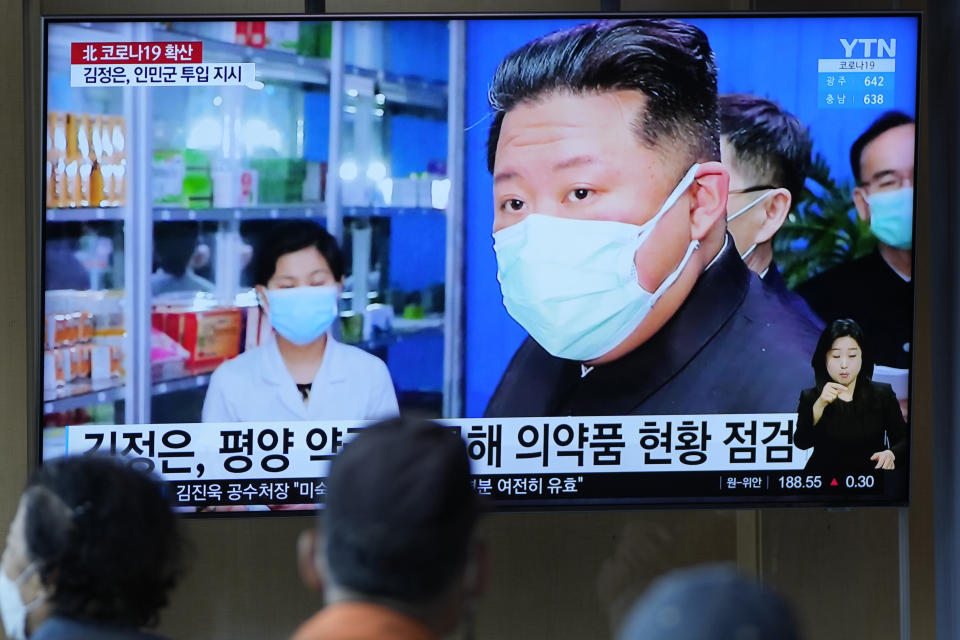 FILE - People watch a TV screen showing a news program reporting with an image of North Korean leader Kim Jong Un, at a train station in Seoul, South Korea on May 16, 2022. North Korea said Friday, May 20, that nearly 10% of its 26 million people have fallen ill and 65 people have died amid its first COVID-19 outbreak, as outside experts question the validity of its reported fatalities and worry about a possible humanitarian crisis. (AP Photo/Lee Jin-man, File)