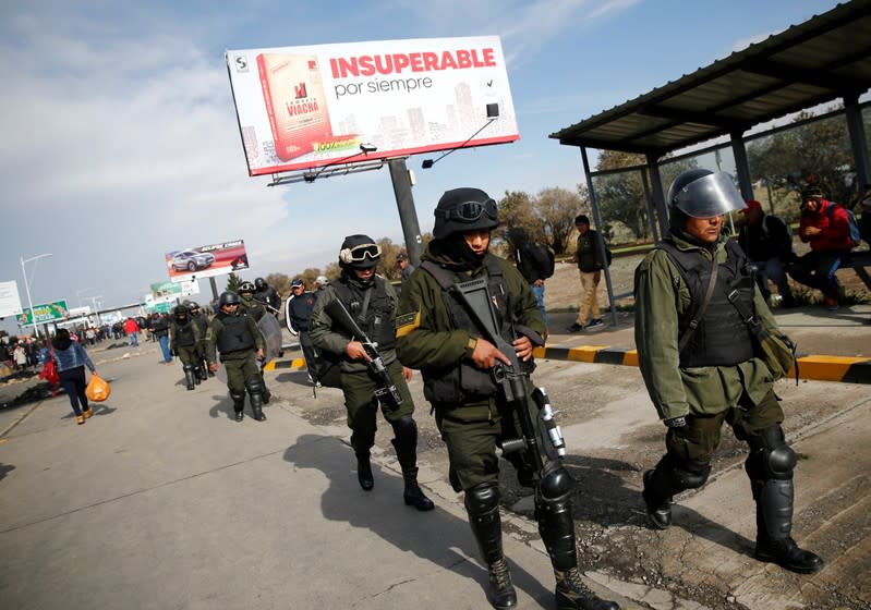 Riot police officers are seen at the El Alto airport, on the outskirts of La Paz