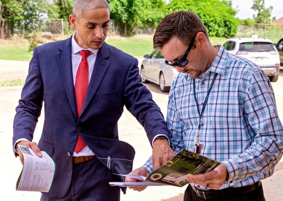 George Williams, president of the Alpha Community Foundation of Oklahoma, discusses proposed floor plans with Scott Wise, with the city of Oklahoma City's development services, during Wise's 2021 site visit to the former Garden Oaks Elementary School, 3401 NE 16.