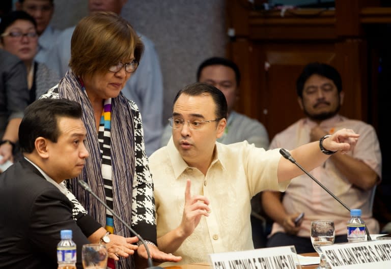 Philippine Senators hold talks as they question a former death squad member during a parliamentary hearing in Manila, on September 15, 2016