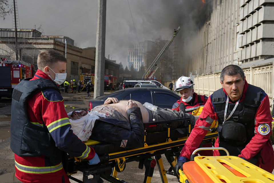 Medics evacuate a wounded man at the site of a Russian attack in Kharkiv, Ukraine, Wednesday, March 20, 2024. (AP Photo/Efrem Lukatsky)