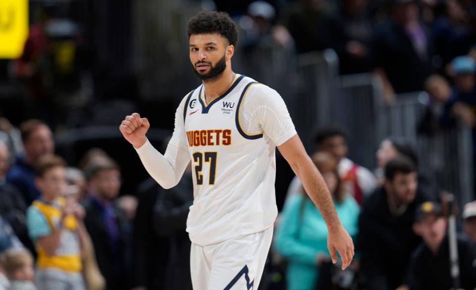 Denver Nuggets guard Jamal Murray gestures to the crowd after hitting a pair of free throws late in the second half of an NBA basketball game against the Utah Jazz, Saturday, Dec. 10, 2022, in Denver. (AP Photo/David Zalubowski)