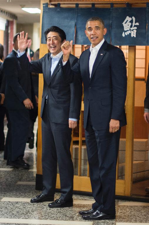 US President Barack Obama (R) and Japanese Prime Minister Shinzo Abe depart after a private dinner at Sukiyabashi Jiro restaurant in Tokyo on April 23, 2014