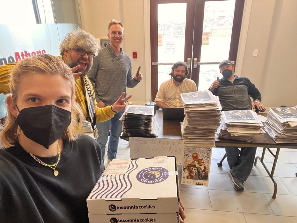 Members of the Athens Banner-Herald pose for a picture while selling commemorative national championship newspapers in January.