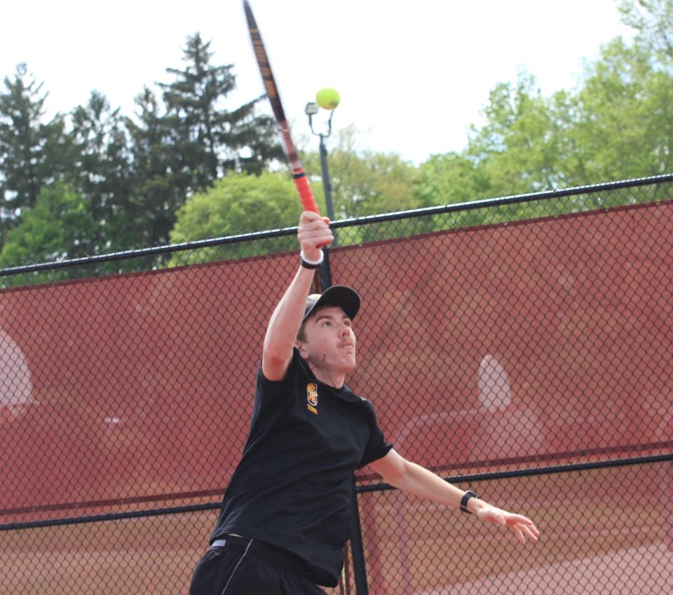 Watkins Memorial's Liam Grennan hits a return at the net during an April 30 match at Newark. Grennan, a senior, enters the district tournament with 101 career wins and in search of his first Division I state tournament berth.