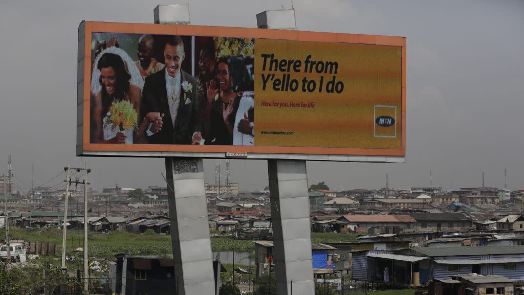 In this photo taken Tuesday, Nov. 17, 2015, an MTN advertisement is seen on a giant electronic board over a slum in Lagos, Nigeria. Nigeria's authorities have levied a US dlrs 5.2 billion fine to Africa’s largest telecommunications company, MTN, for having 5.2 million active but unregistered SIM cards, which authorities allege are a matter of national security in Nigeria and may have caused deaths. The dlrs 5.2 billion fine is far more than any company has been fined anywhere in the world according to industry expert John Strand of Denmark-based Strand Consult.