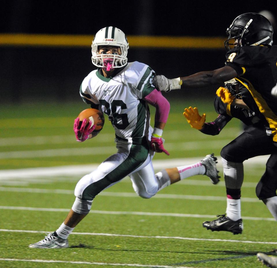 Dennis-Yarmouth wide receiver Andrew Jamiel runs around two Nauset defenders in this October 2015 game. Jamiel is now one of the top receivers during the inaugural season of Fan Controlled Football, which airs on www.twitch.tv.