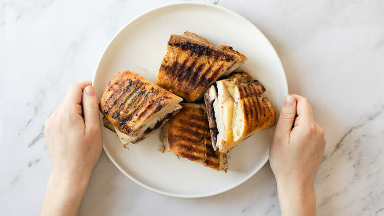 Person serving a platter with panini pieces