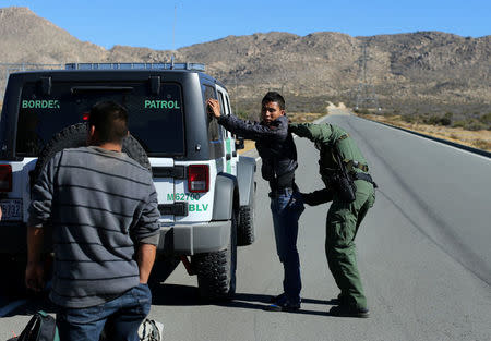 U.S. Border Patrol supervisor Bobby Stine frisks a man a few hundred meters from the U.S.-Mexico border fence near Jacumba, California, U.S., November 14, 2016. REUTERS/Mike Blake