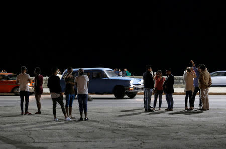 People stand on the seafront boulevard El Malecon in Havana, Cuba, November 26, 2016. REUTERS/Stringer