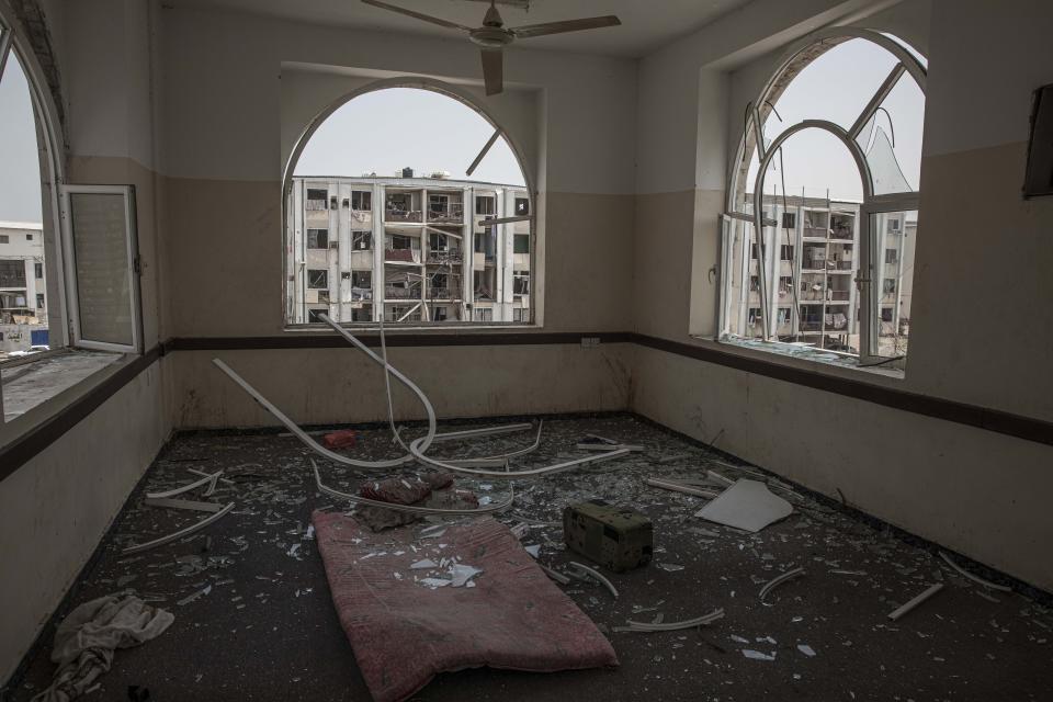 Damage can be seen at the site of a deadly attack on the Sheikh Othman police station, in Aden, Yemen, Thursday, Aug. 1, 2019. Yemen's rebels fired a ballistic missile at a military parade Thursday in the southern port city of Aden as coordinated suicide bombings targeted the police station in another part of the city. The attacks killed over 50 people and wounded dozens. (AP Photo/Nariman El-Mofty)
