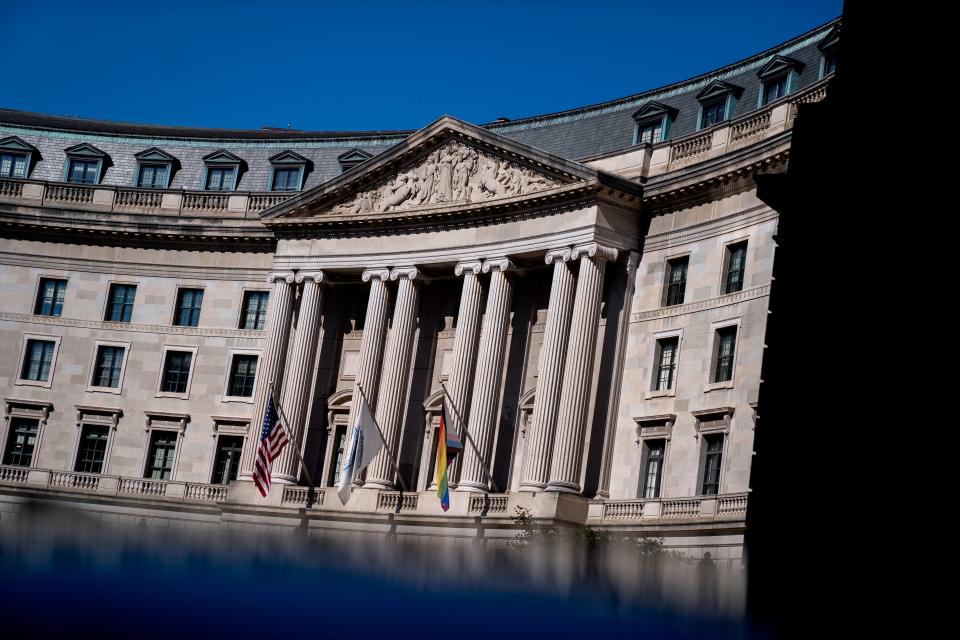 The colonnades of the Environmental Protection Agency, with three flags flying.