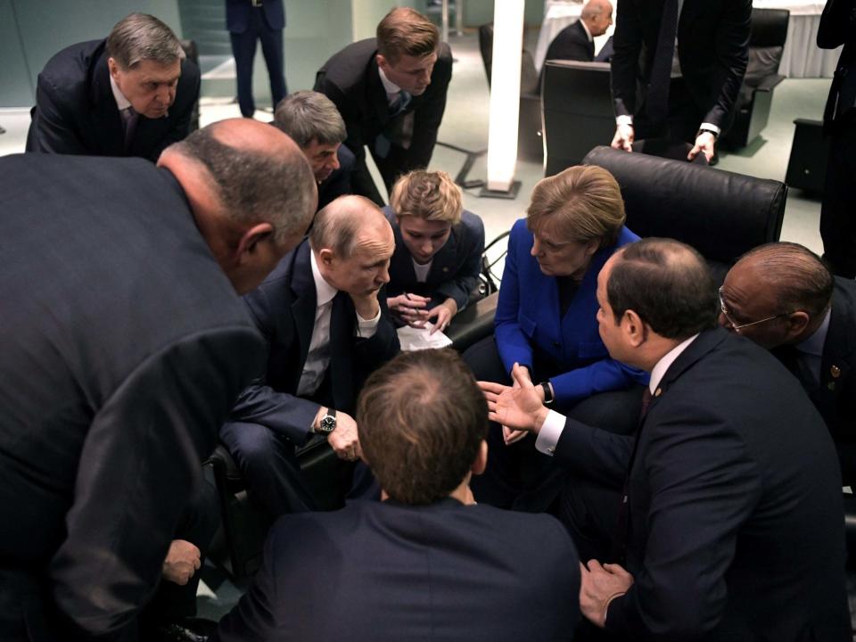 Vladimir Putin, Angela Merkel and Egypt's Abdul Fattah al-Sisi talk on the sidelines of Sunday's summit in Berlin: VIA REUTERS