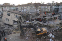 Rescuers work on searching for people buried under the rubble on a collapsed building, after an earthquake struck Elazig, eastern Turkey, Saturday, Jan. 25, 2020. Rescue workers were continuing to search for people buried under the rubble of apartment blocks in Elazig and neighbouring Malatya. Mosques, schools, sports halls and student dormitories were opened for hundreds who left their homes after the quake.(Can Celik/DHA via AP)