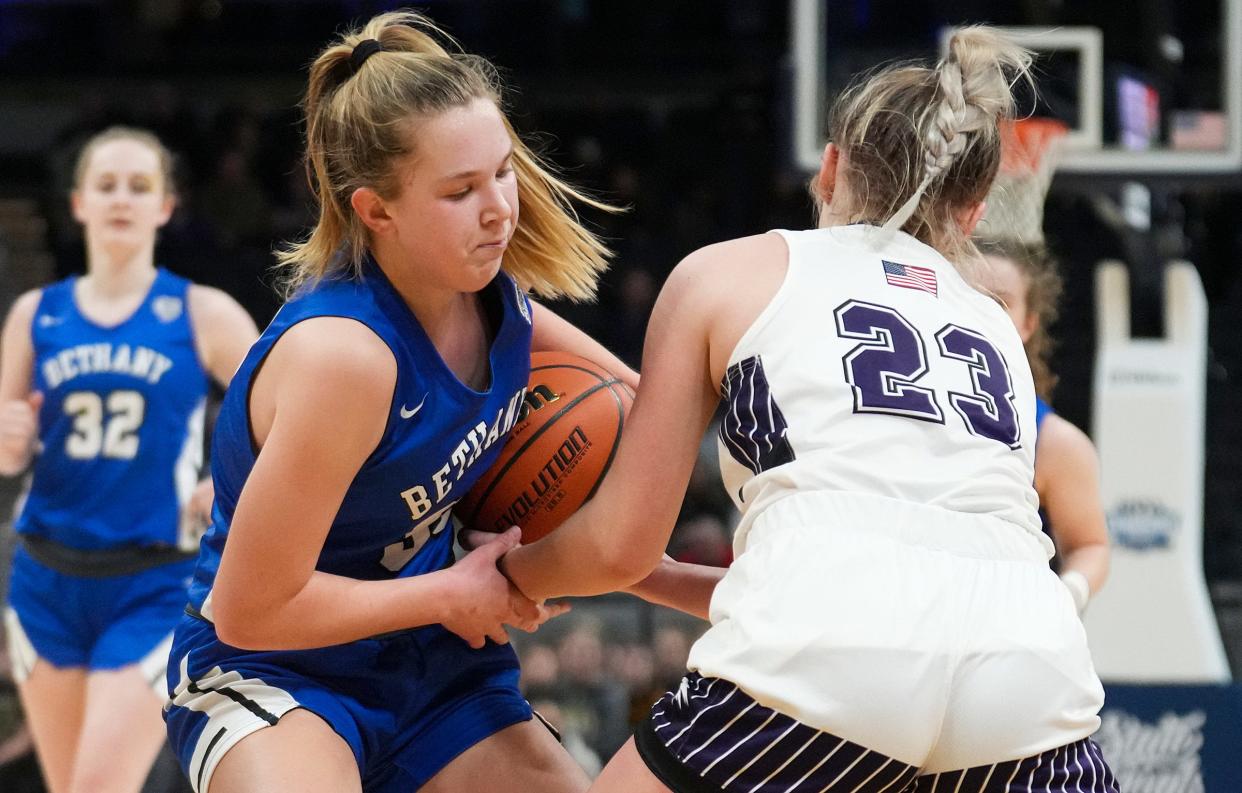 Lanesville Eagle Hylton Brumley (23) tries to strip the ball from Bethany Christian Bruin Zoe Willems (30) on Saturday, Feb. 25, 2023, during the IHSAA Class A state championship game at Gainbridge Fieldhouse in Indianapolis. 