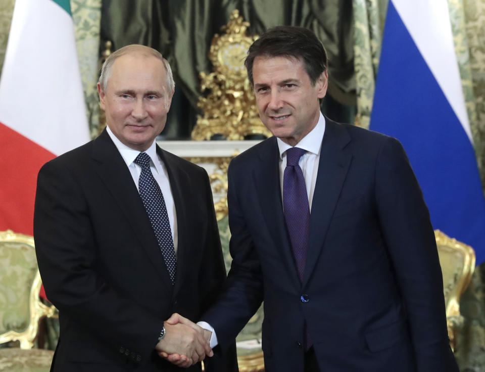 Russian President Vladimir Putin, left, shakes hands with Italian Prime Minister Giuseppe Conte during their meeting in the Kremlin in Moscow, Russia, Wednesday, Oct. 24, 2018. Italian Prime Minister Giuseppe Conte is holding talks with Russian officials on his first trip to Moscow. (Sergei Chirikov/Pool Photo via AP)