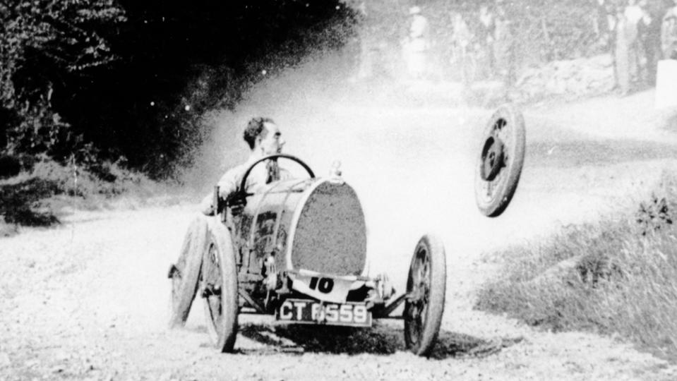 Racer Raymond May loses a wheel from his Bugatti during competition, circa early 1930s.