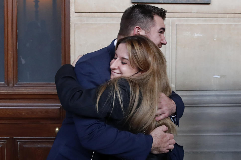 Train host Shauna Asley Verstichelen greets Alek Skarlatos, at the end of their hearing during the Thalys attack trial at the Paris courthouse, Friday, Nov. 20, 2020. Passengers who wrestled and disarmed an Islamic State gunman aboard a high-speed Amsterdam to Paris train are recounting how their split-second decisions helped prevent what could have become a mass slaughter. (AP Photo/Francois Mori)