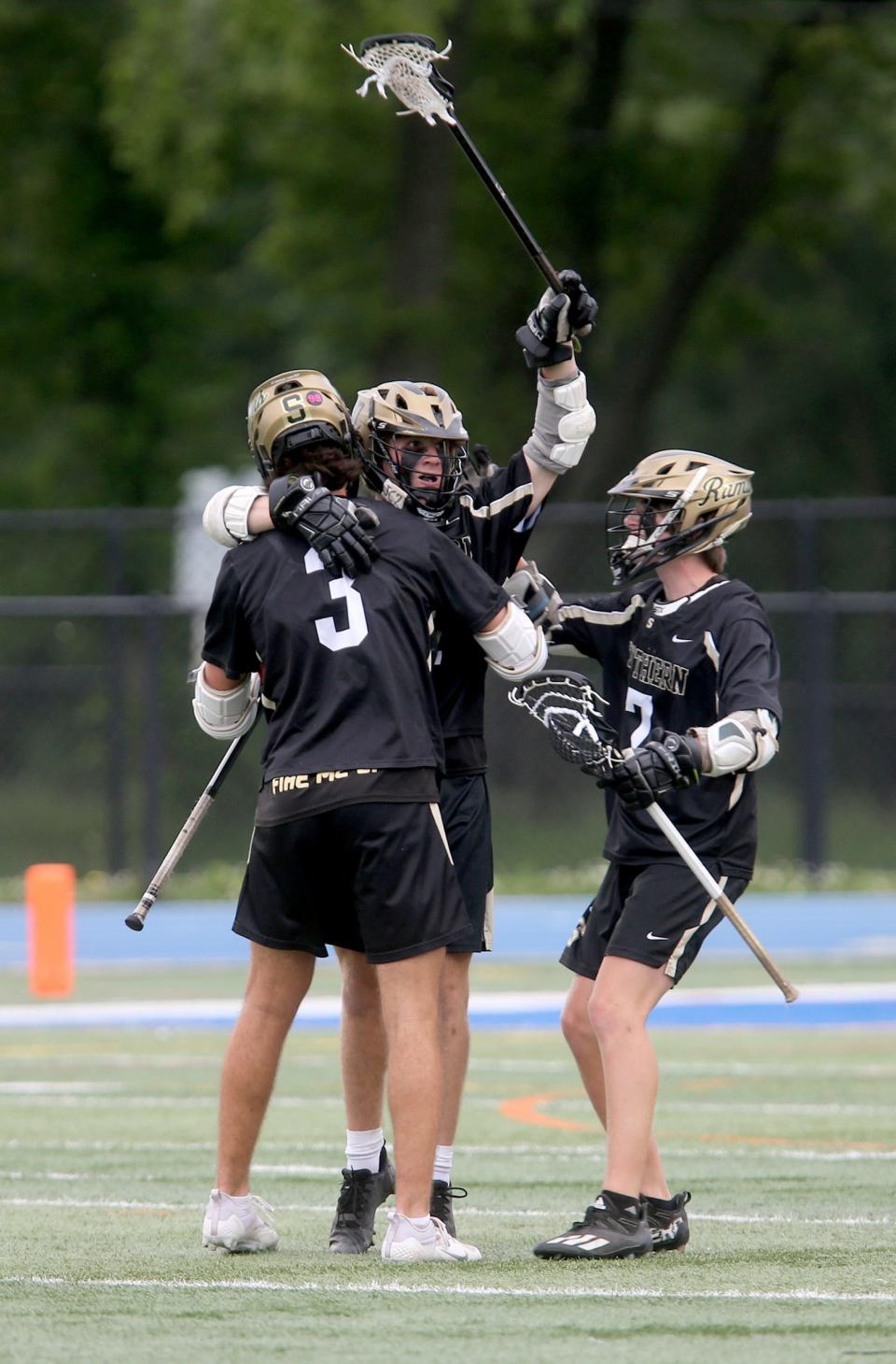 Southern Regional's Zach Washco (center) celebrates a goal against ridgewater Raritan with Joey DeYoung (#3) and Hayden Lucas (#7) during their NJSIAA Group IV State Final game at Shore Regional High School in West Long Branch Wednesday, June 1, 2022.  