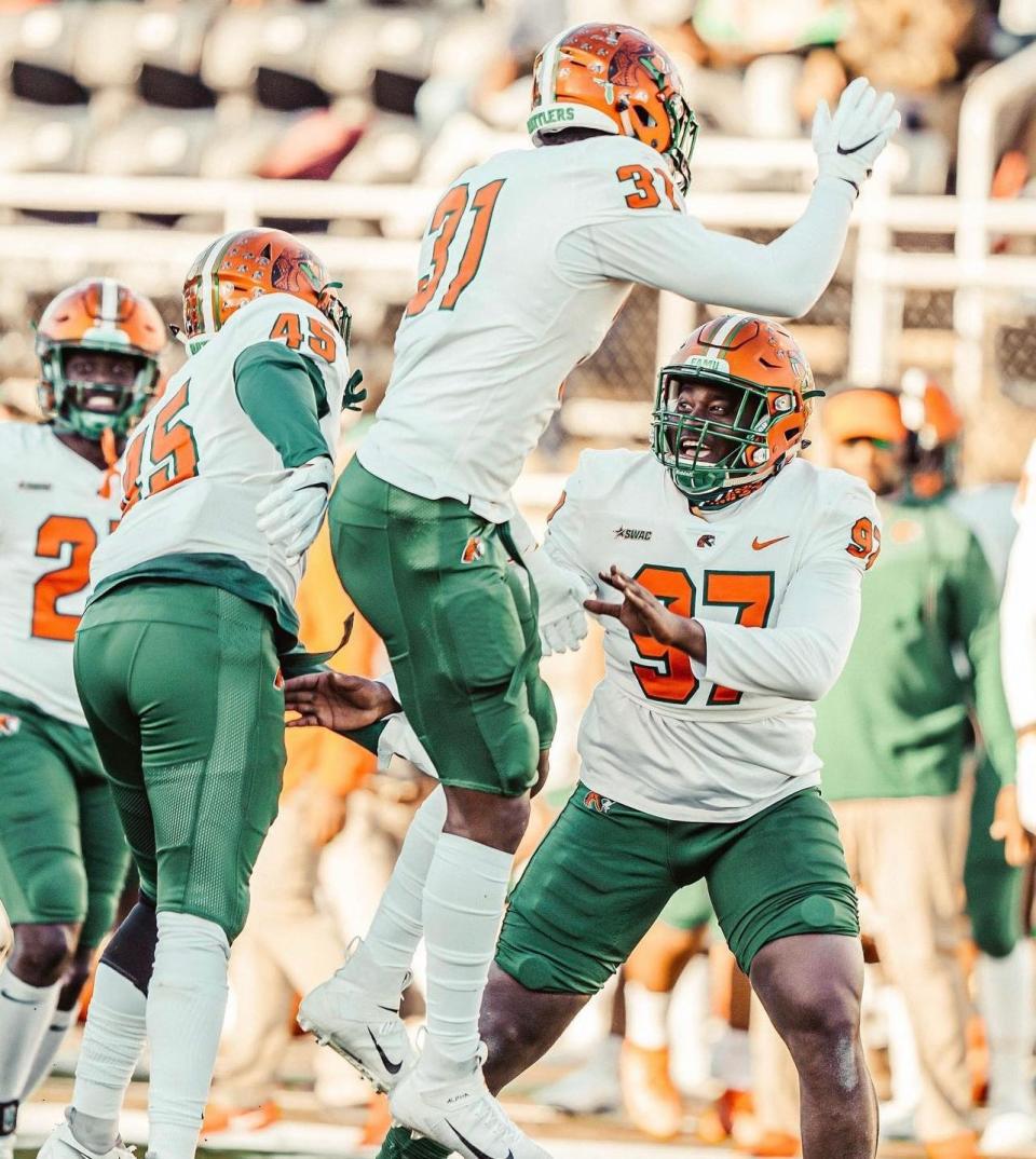 Florida A&M football defensive lineman Kamari Stephens (97) celebrates with teammates during a game against Arkansas-Pine Bluff at Simmons Bank Field in Pine Bluff, Arkansas, Saturday, November 13, 2021