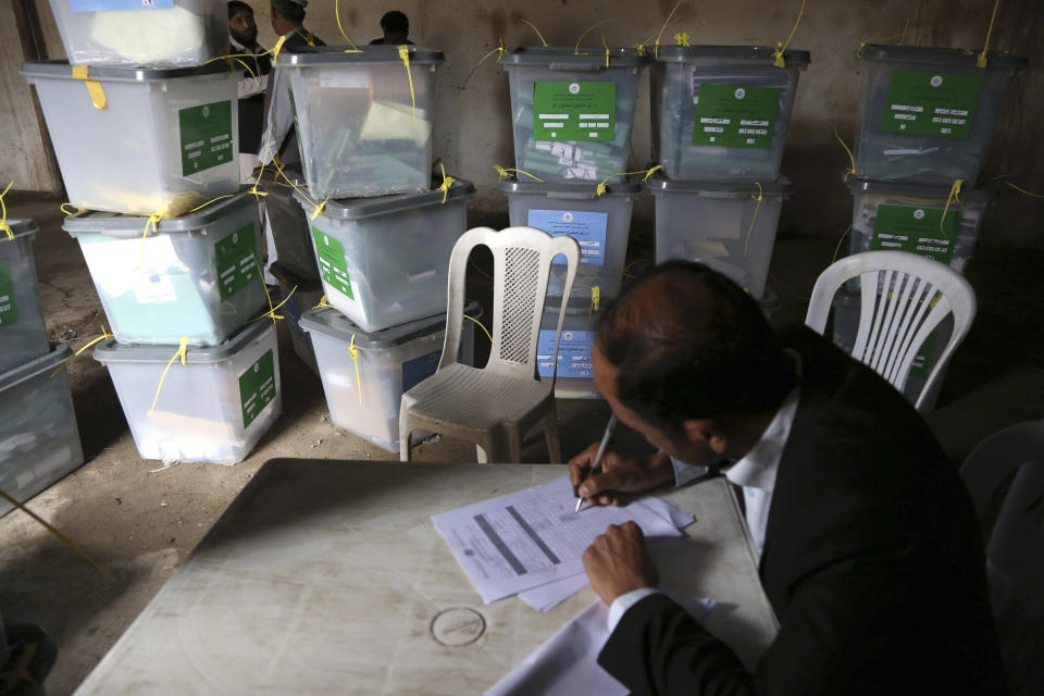 An Afghan ballot counter reads the instruction on how to count and register votes in Jalalabad, east of Kabul, Afghanistan, Sunday, April 6, 2014. Across Afghanistan, voters turned out in droves Saturday to cast ballots in a crucial presidential election. The vote will decide who will replace President Hamid Karzai, who is barred constitutionally from seeking a third term. Partial results are expected as soon as Sunday. (AP photo/Rahmat Gul)