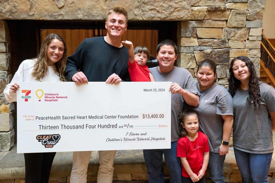 Bo Nix presents a check on Monday from Children's Miracle Network Hospitals and 7-Eleven to PeaceHealth Sacred Heart Medical Center RiverBend in Springfield.