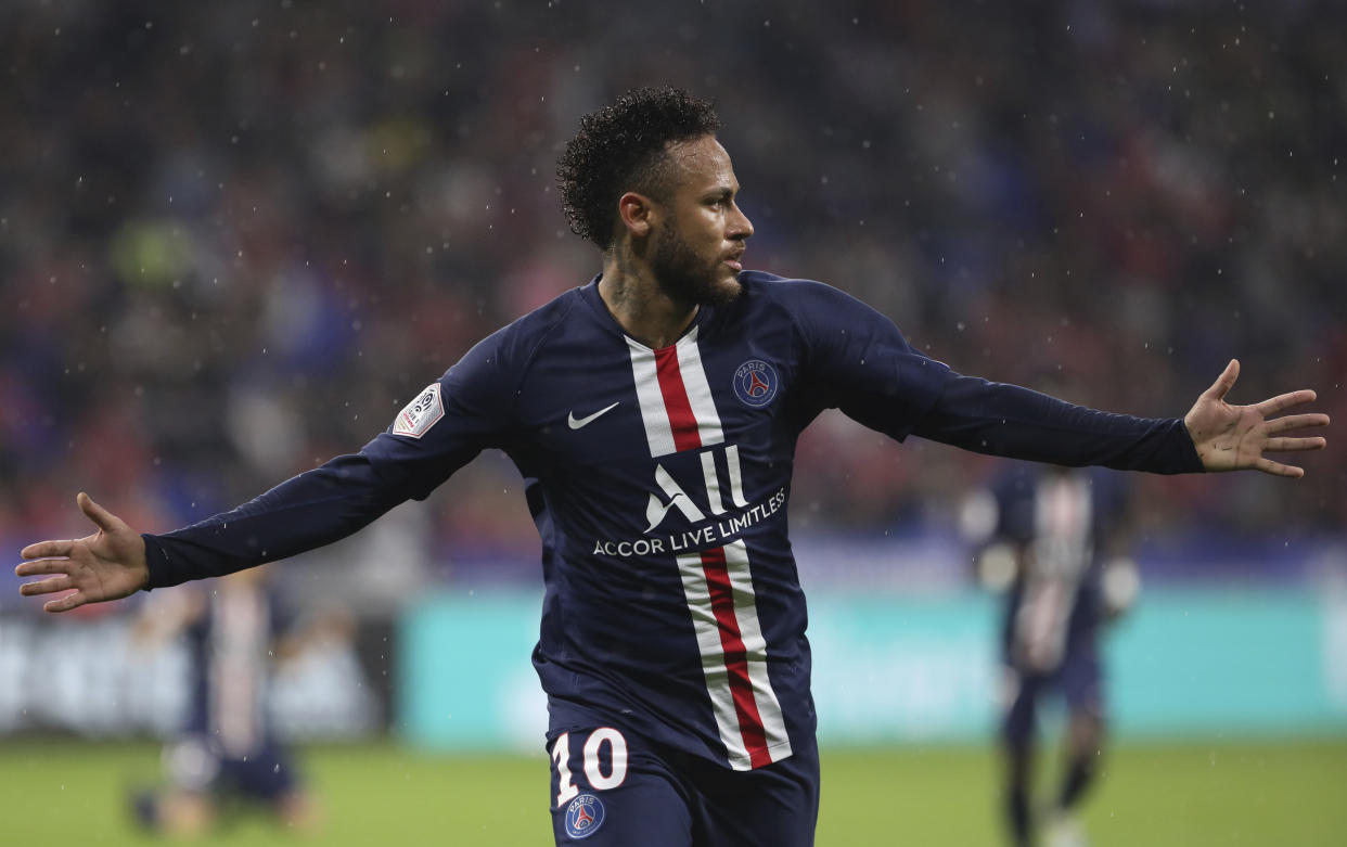 PSG's Neymar celebrates after scoring the opening goal of the game during the French League 1 soccer match between Lyon and Paris SG, at the Stade de Lyon in Decines, outside Lyon, France, Sunday, Sept. 22, 2019. (AP Photo/Laurent Cipriani)