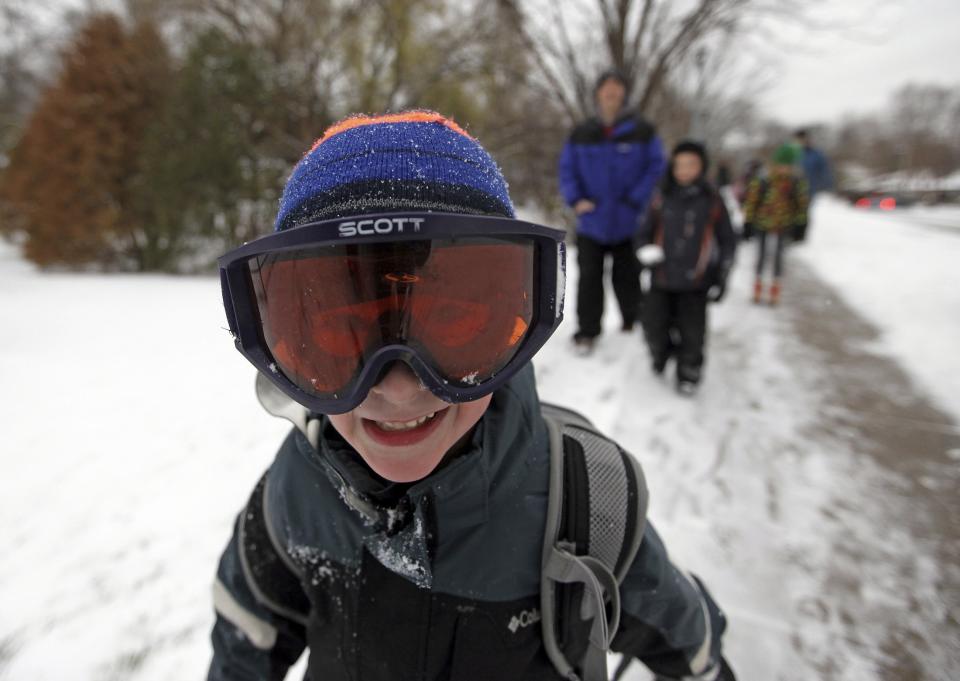 Jacob Rowell wears ski googles as he walks to school in Minneapolis, November 10, 2014. An arctic blast began to dump heavy snow in parts of the northern Rockies, Plains and the Great Lakes regions on Monday and meteorologists said temperatures are expected to plummet throughout the United States. (REUTERS/Eric Miller)