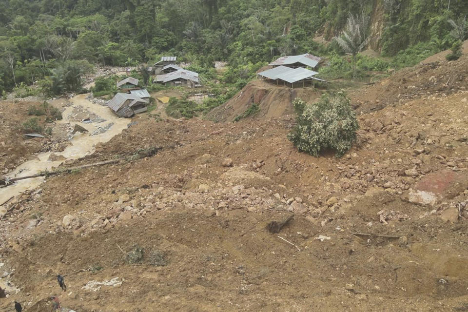 In this photo released by the Indonesian National Search and Rescue Agency (BASARNAS), rescuers search for victims at the site of a landslide in Bone Bolango in Gorontalo province, Indonesia, Wednesday, July 10, 2024. Search efforts for those trapped in a deadly landslide intensified Wednesday, with more rescuers deployed to search an unauthorized gold mine on Indonesia's Sulawesi island that saw a number of deaths over the weekend. (BASARNAS via AP)