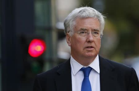 Britain's Secretary of State for Defence Michael Fallon leaves 10 Downing Street after a COBR meeting in central London August 13, 2014. REUTERS/Suzanne Plunkett