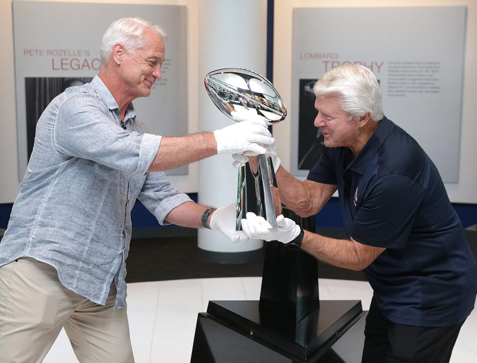Daryl Johnston, left,  executive vice president of football operations for the USFL and three-time Super Bowl champion sets out the Super Bowl 57 Vince Lombardi Trophy along with former Super Bowl-winning coach Jimmy Johnson, Friday at the Pro Football Hall of Fame.
