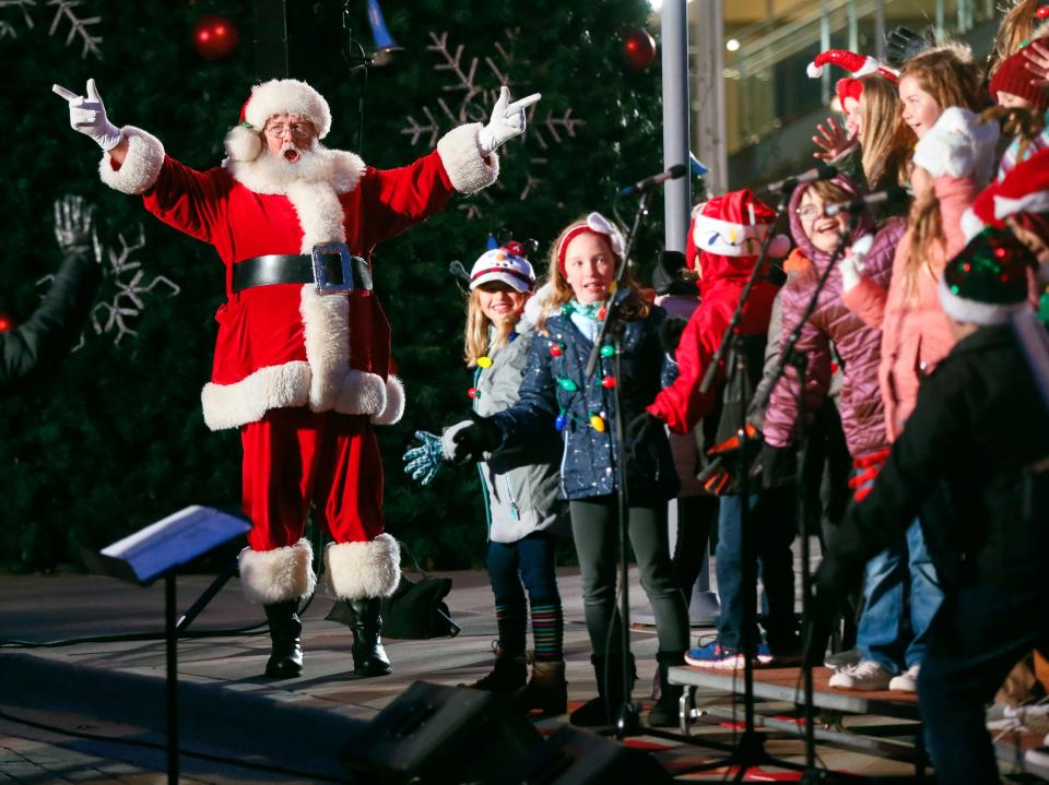 Santa Claus sings along with the Edmond Youth Chorus during the Governor's Christmas Tree Lighting at the Oklahoma History Center in Oklahoma City, Monday, Dec. 9, 2019. [Nate Billings/The Oklahoman]