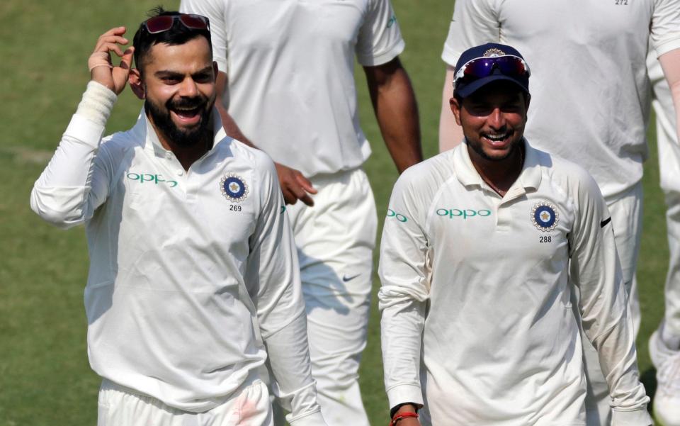 Virat Kohli (left) is all smiles as he leads his victorious India side off the field - AP