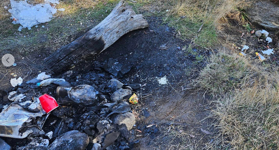 A burnt fire pit with plastic in it at the Kosciuszko National Park. 