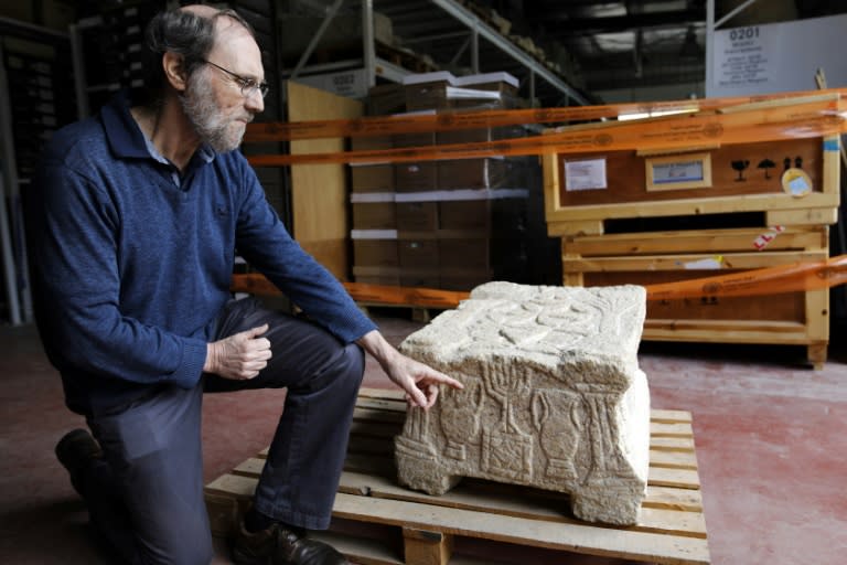 Professor Gideon Avni of the Israel Antiquities Authority displays the original Magdala Stone which was discovered in a Galilean synagogue dating to the Second Temple period (50 BC-100 AD)