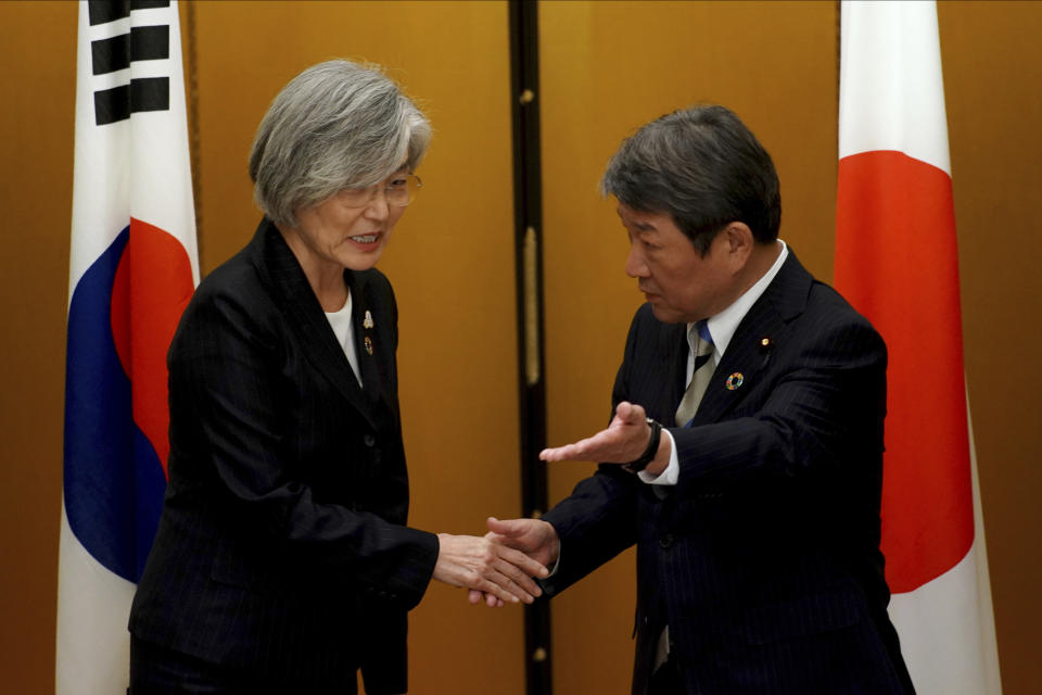 Japan's Foreign Minister Toshimitsu Motegi, right, meets with South Korea's Foreign Minister Kang Kyung-wha before a bilateral meeting during the G20 foreign ministers meeting Saturday, Nov. 23, 2019, in Nagoya, Japan. (AP Photo/Eugene Hoshiko, Pool)