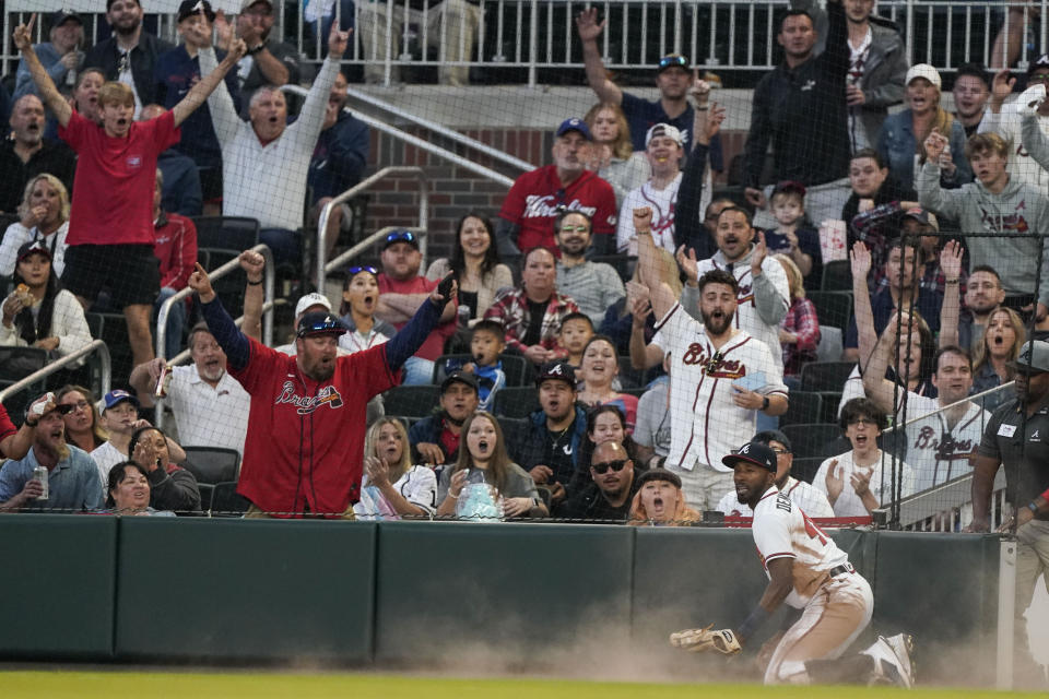 Atlanta Braves' Travis Demeritte (48) reacts after making a diving catch on a fly ball for an out by Chicago Cubs' Yan Gomes in the fourth inning of a baseball game, Tuesday, April 26, 2022, in Atlanta. (AP Photo/Brynn Anderson)
