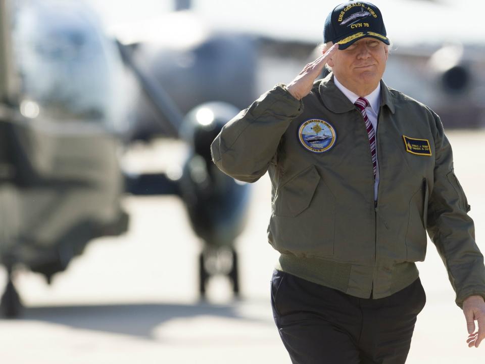 US President Donald Trump salutes as he walks to Air Force One prior to travelling to Newport News, Virginia, in March 2017 to visit the pre-commissioned USS Gerald R. Ford aircraft carrier: SAUL LOEB/AFP/Getty Images