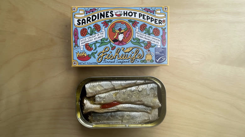 box and open tin of sardines 