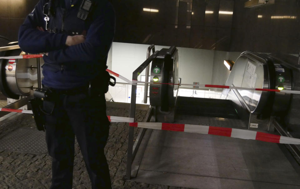 A police officer stands in front of a security tape at a metro station near EU headquarters in Brussels, Monday, Jan. 30, 2023. News reports on Monday said that one man was injured in a knife incident around the European Union's headquarters in Brussels before one suspect was detained. (AP Photo/Sylvain Plazy)