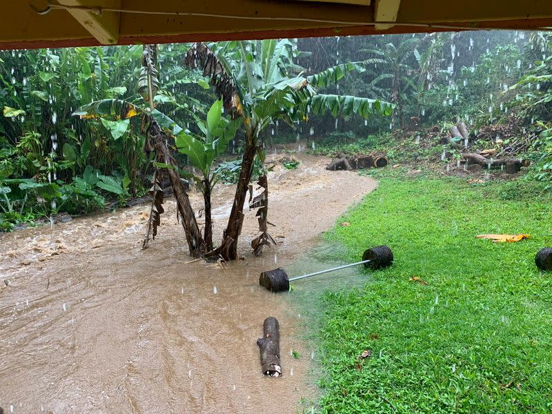 Social media image of floodwater streaming downhill near a residential area in Haiku, Hawaii