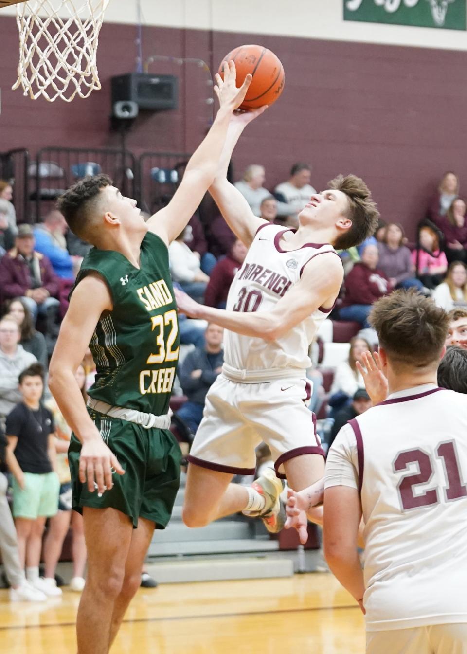 Sand Creek's Trevor Opel defends while Morenci's Bryson Bachelder goes up for a shot last season.