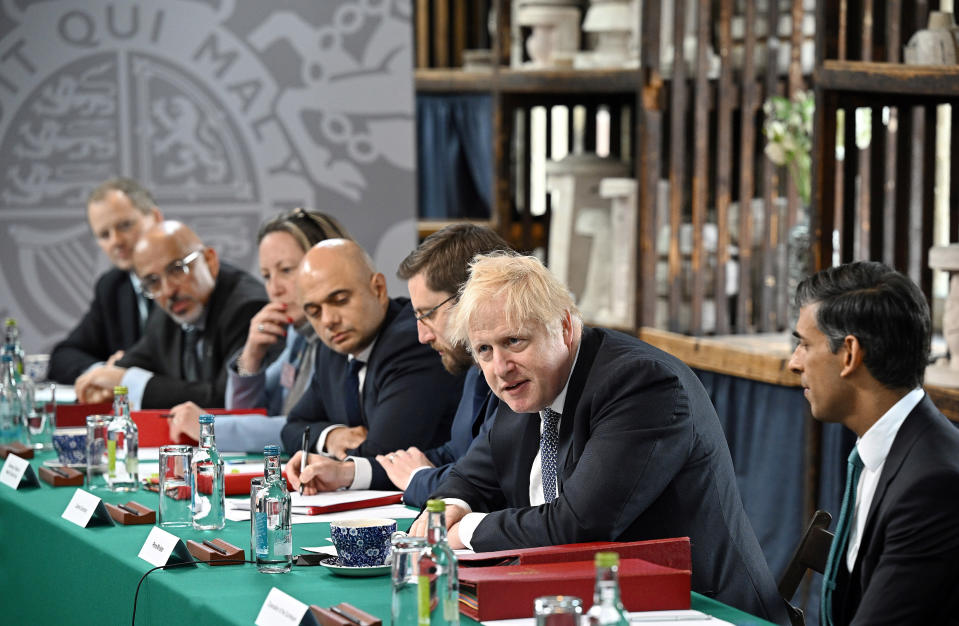 FILE - Britain's Prime Minister Boris Johnson, second from right, chairs a cabinet meeting with, from second from left; Britain's Education Secretary Nadhim Zahawi, Britain's International Trade Secretary Anne-Marie Trevelyan, Britain's Health Secretary Sajid Javid, Britain's Cabinet Secretary and Head of the Civil Service Simon Case and Britain's Chancellor of the Exchequer Rishi Sunak, right, at a pottery in Stoke-on-Trent, England, Thursday, May 12, 2022. Johnson was dealt a major blow Tuesday, July 5, 2022 when two of his most senior Cabinet ministers quit, saying they had lost confidence in Johnson’s leadership. (Oli Scarff/Pool Photo via AP, File)